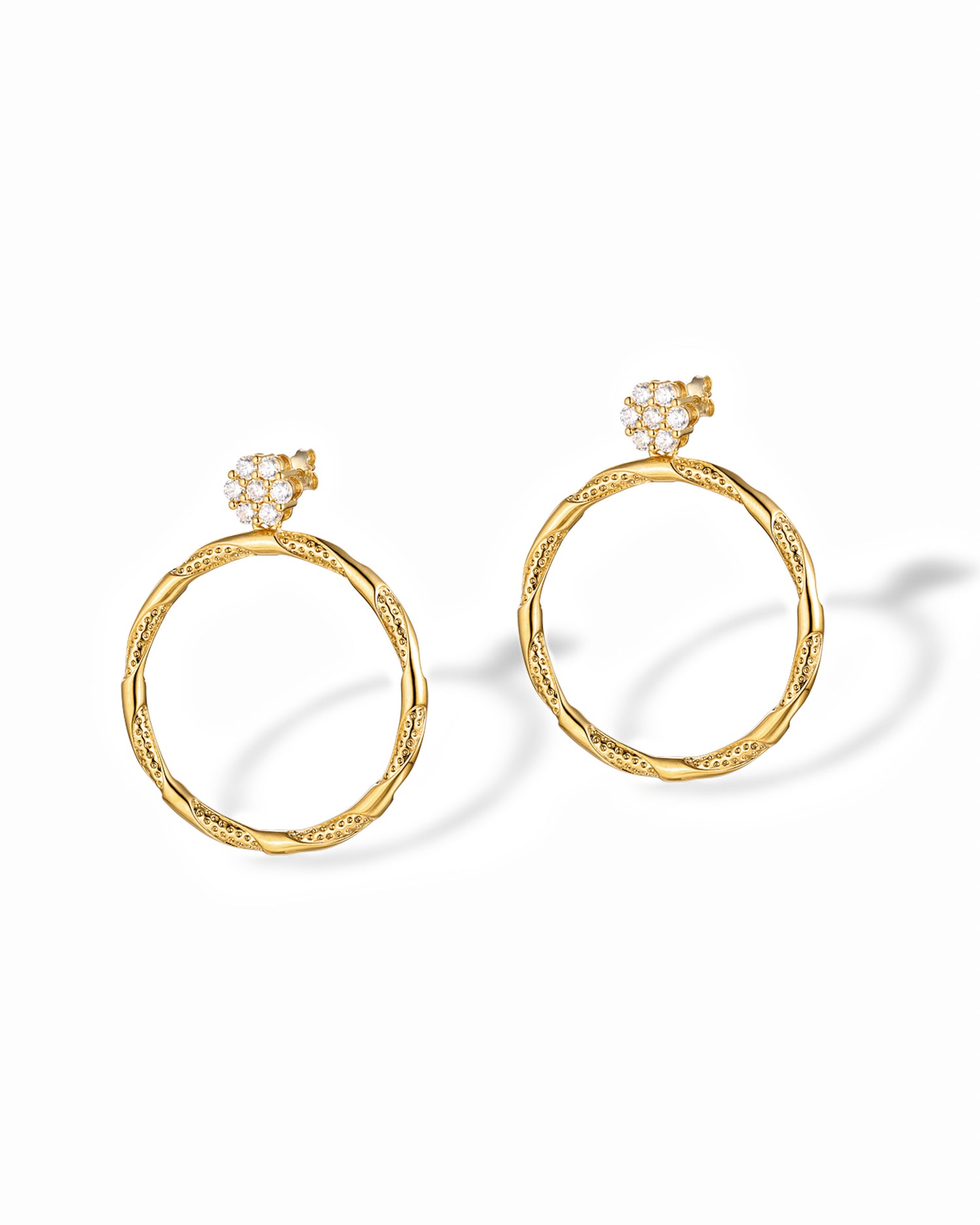 Gold textured hoop earrings with diamond circle charm.