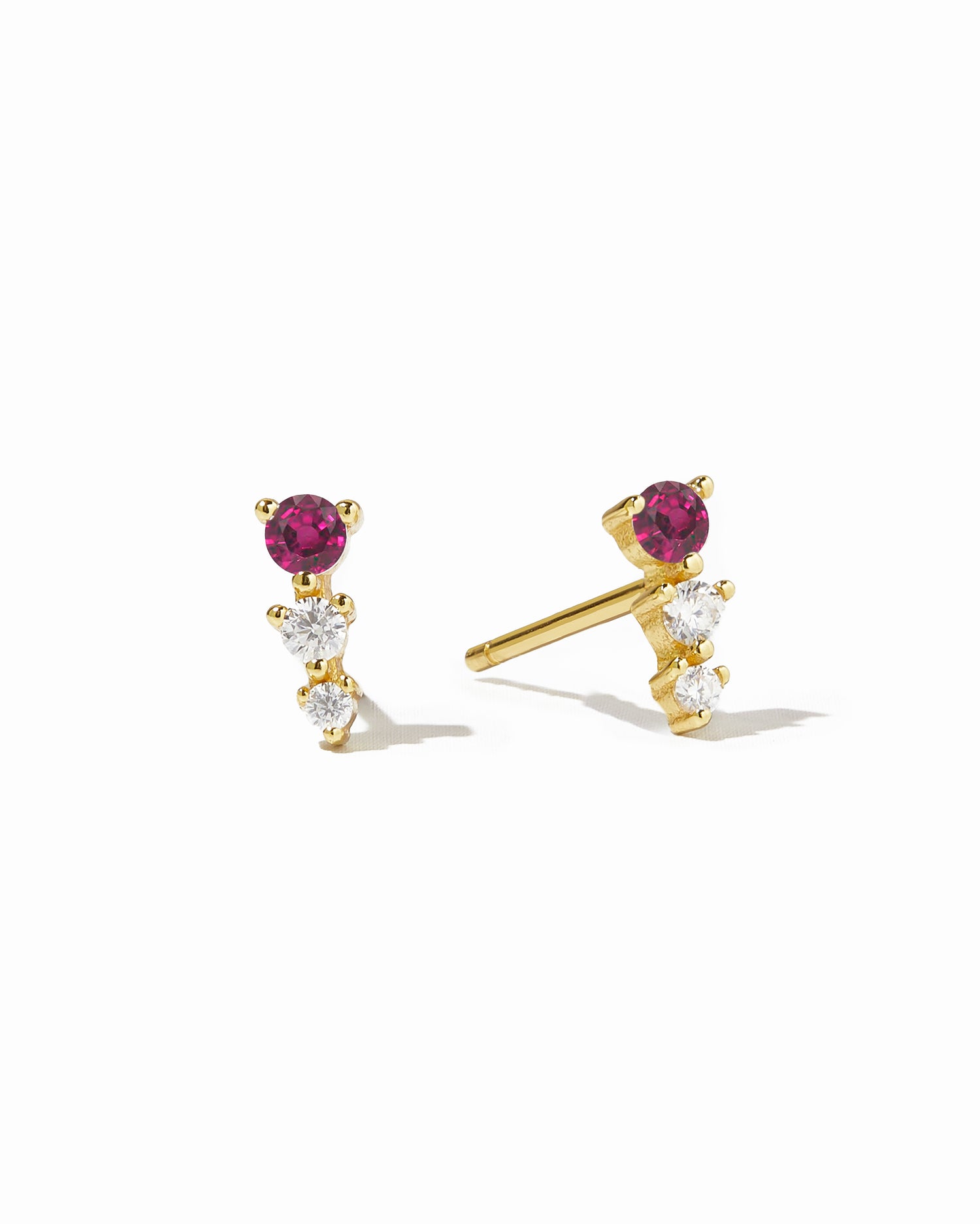Gold ear climber stud earrings with ruby and diamond stones.
