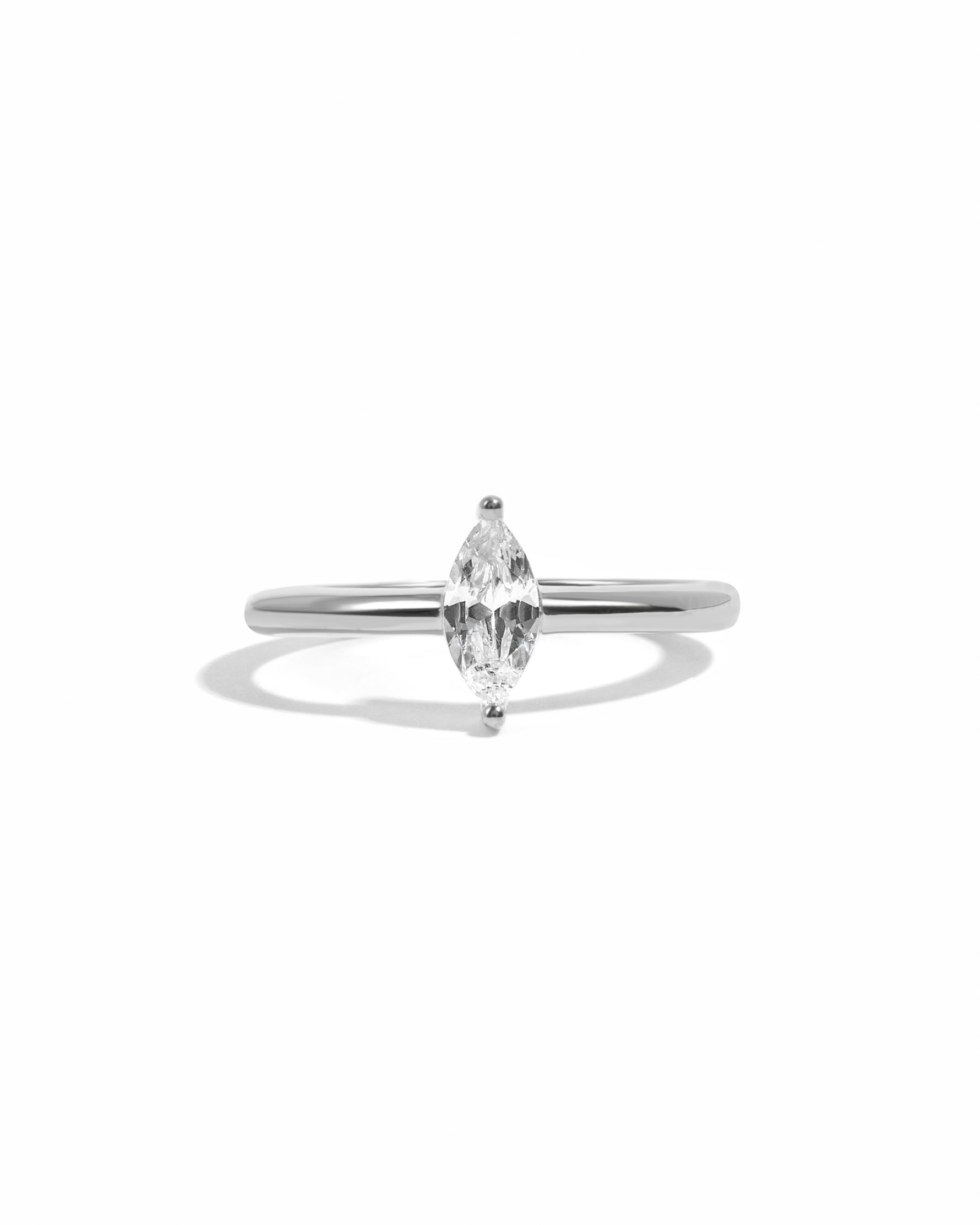 Sterling silver marquise diamond engagement ring on a white background. 