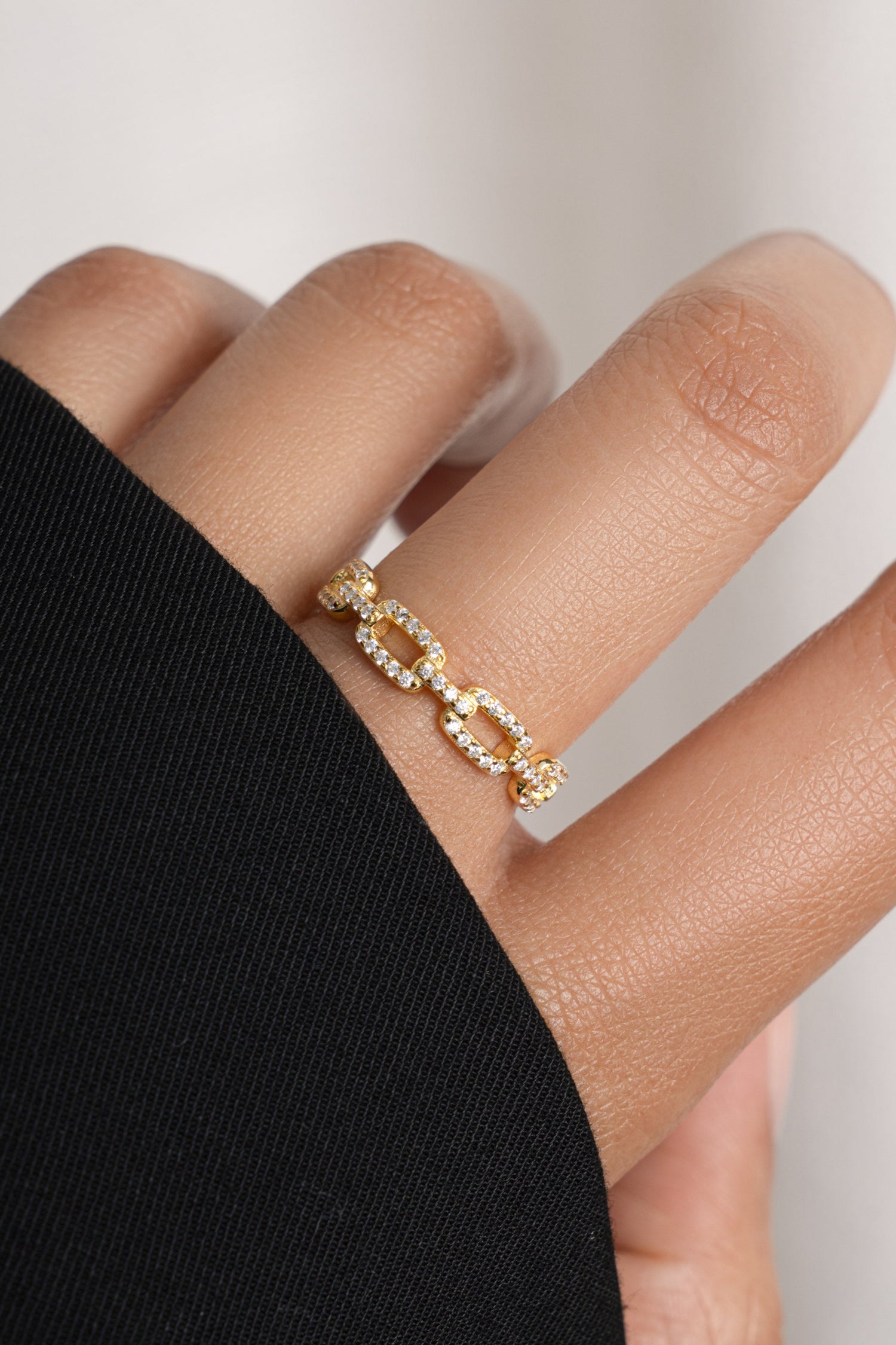 Gold chain link ring with pave diamonds on model.
