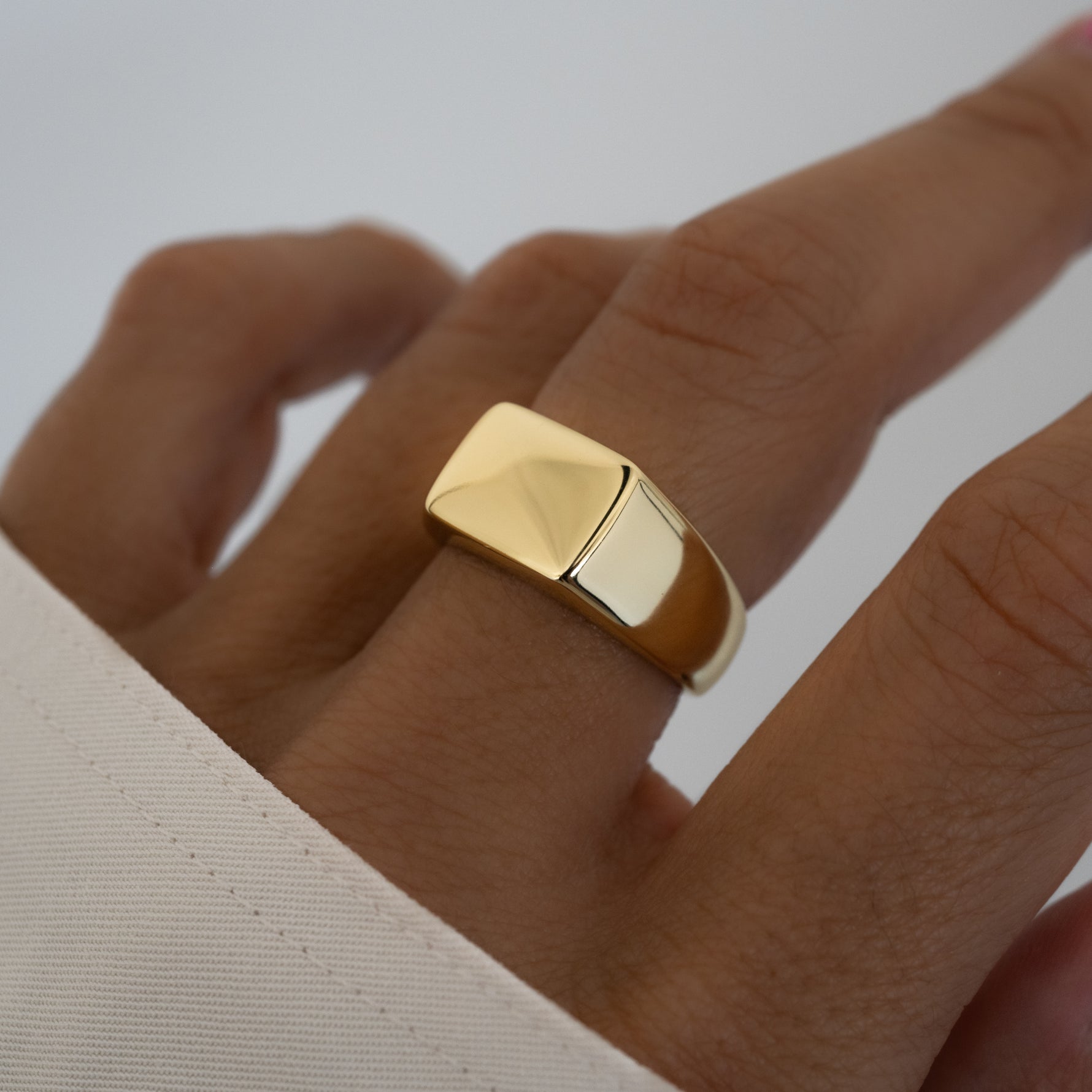 Chunky gold square signet statement ring.