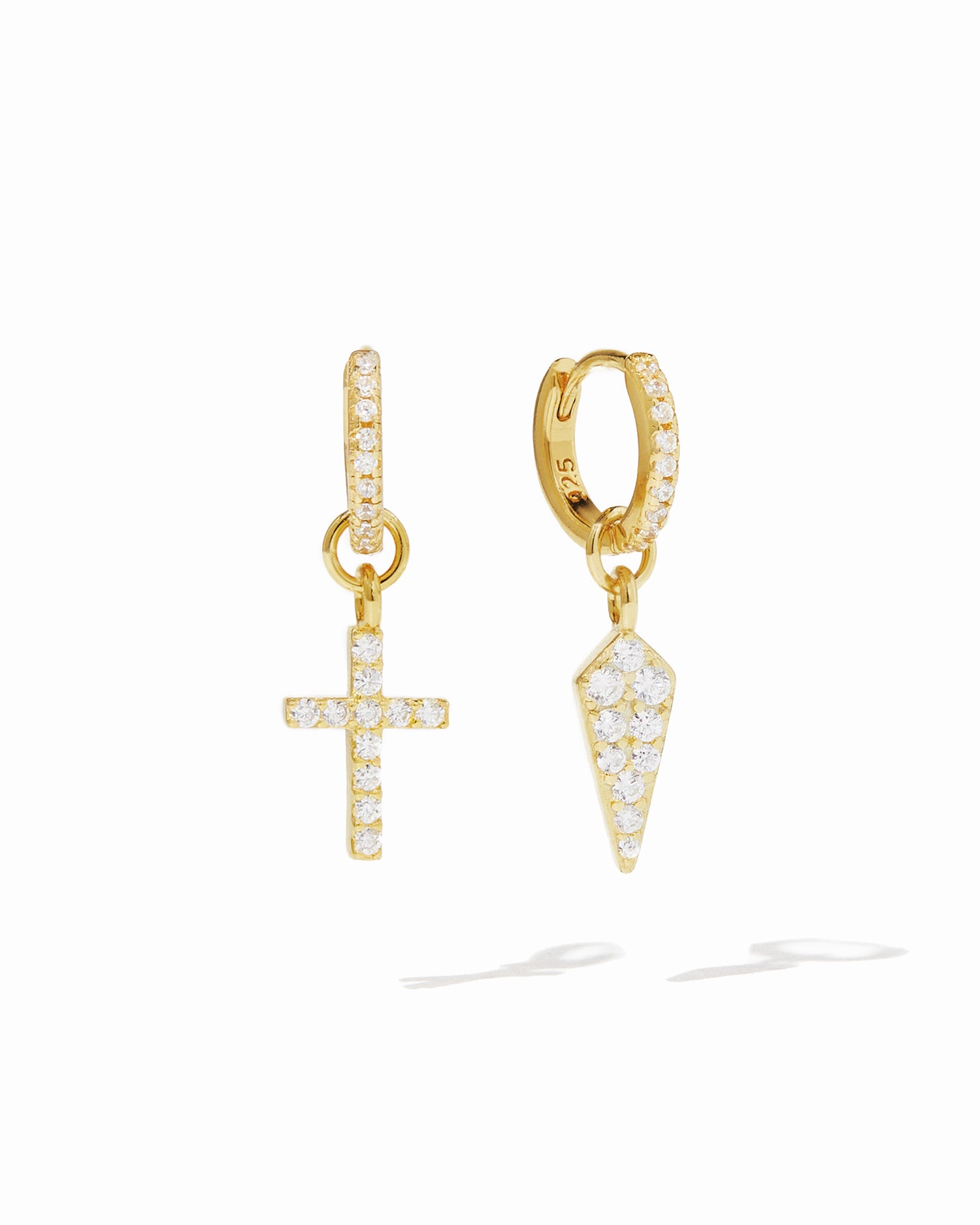 Gold pavé huggie earrings with removable cross and dagger charms. 