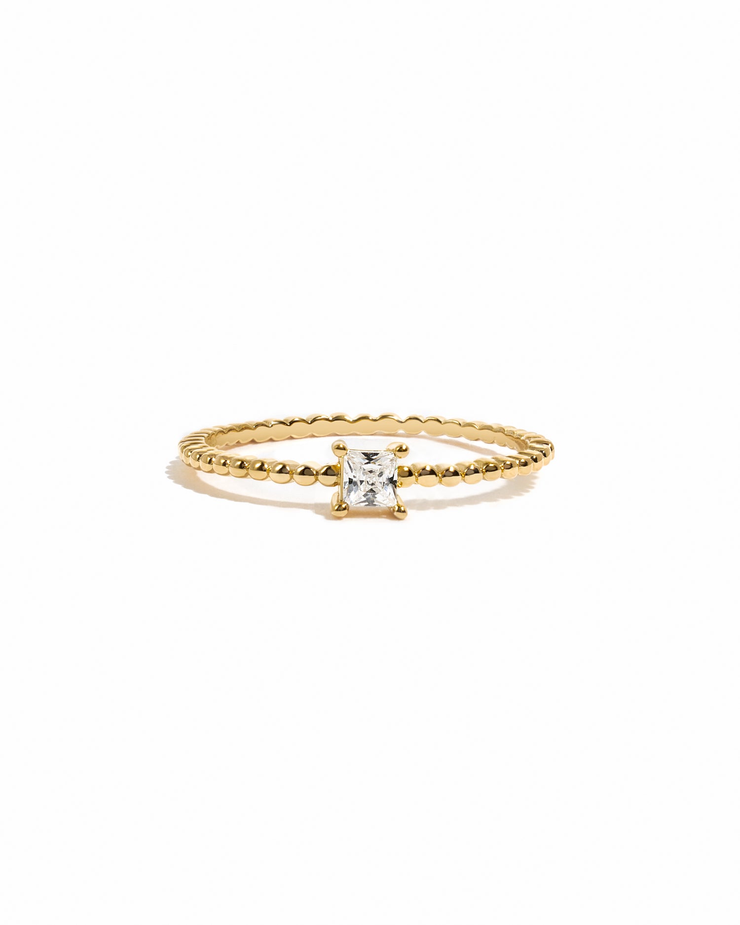 Gold dainty princess cut diamond ring with beaded band.