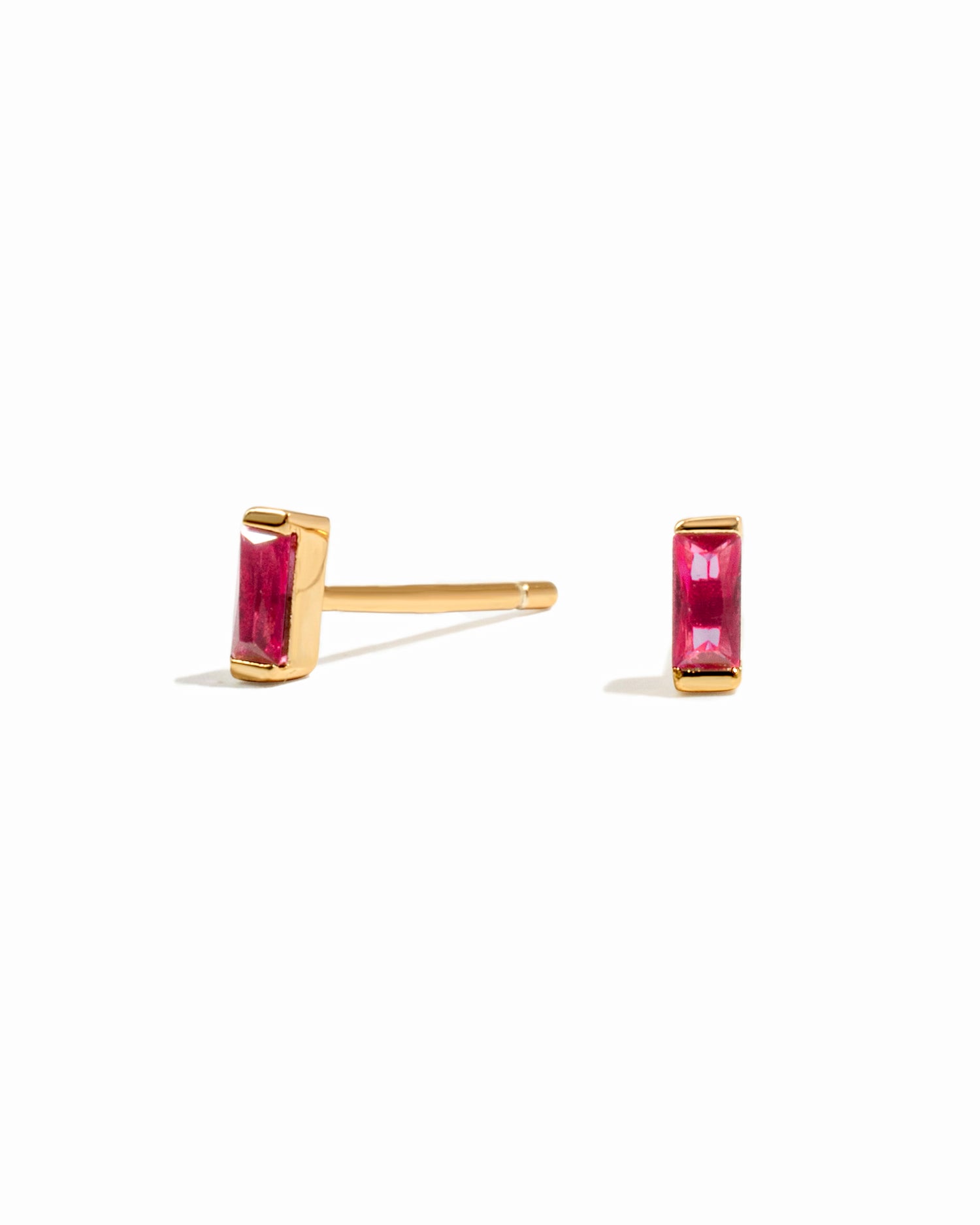 Gold ruby baguette stud earrings.