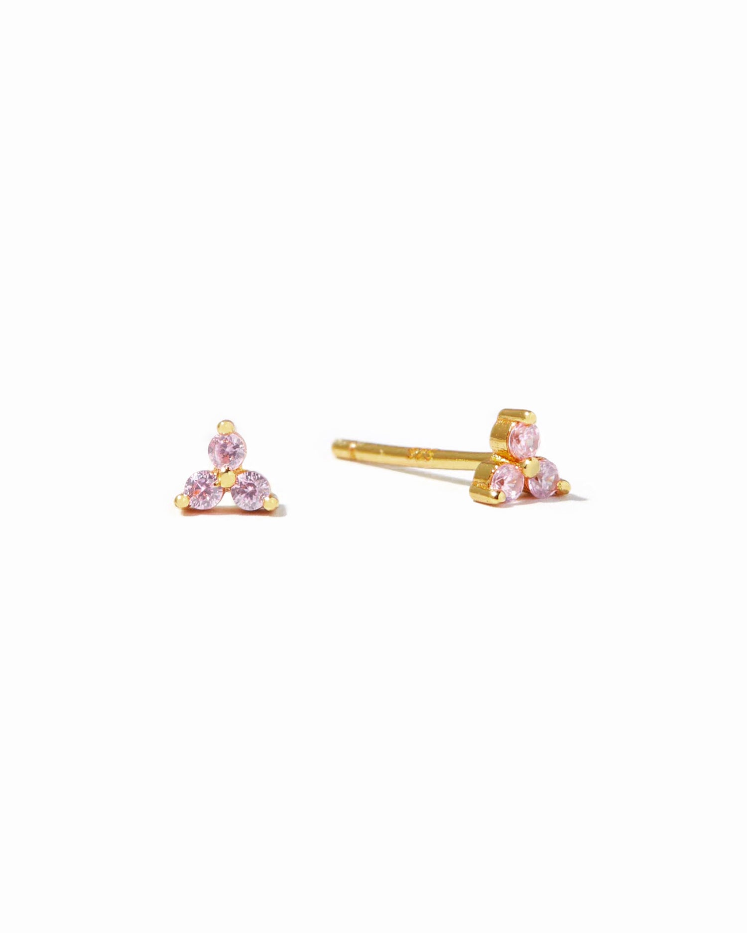 Tiny gold stud earrings with pink gemstones.
