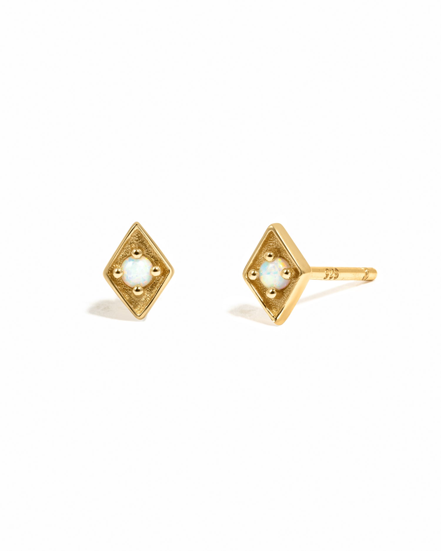 Gold diamond shaped stud earring with opal center.
