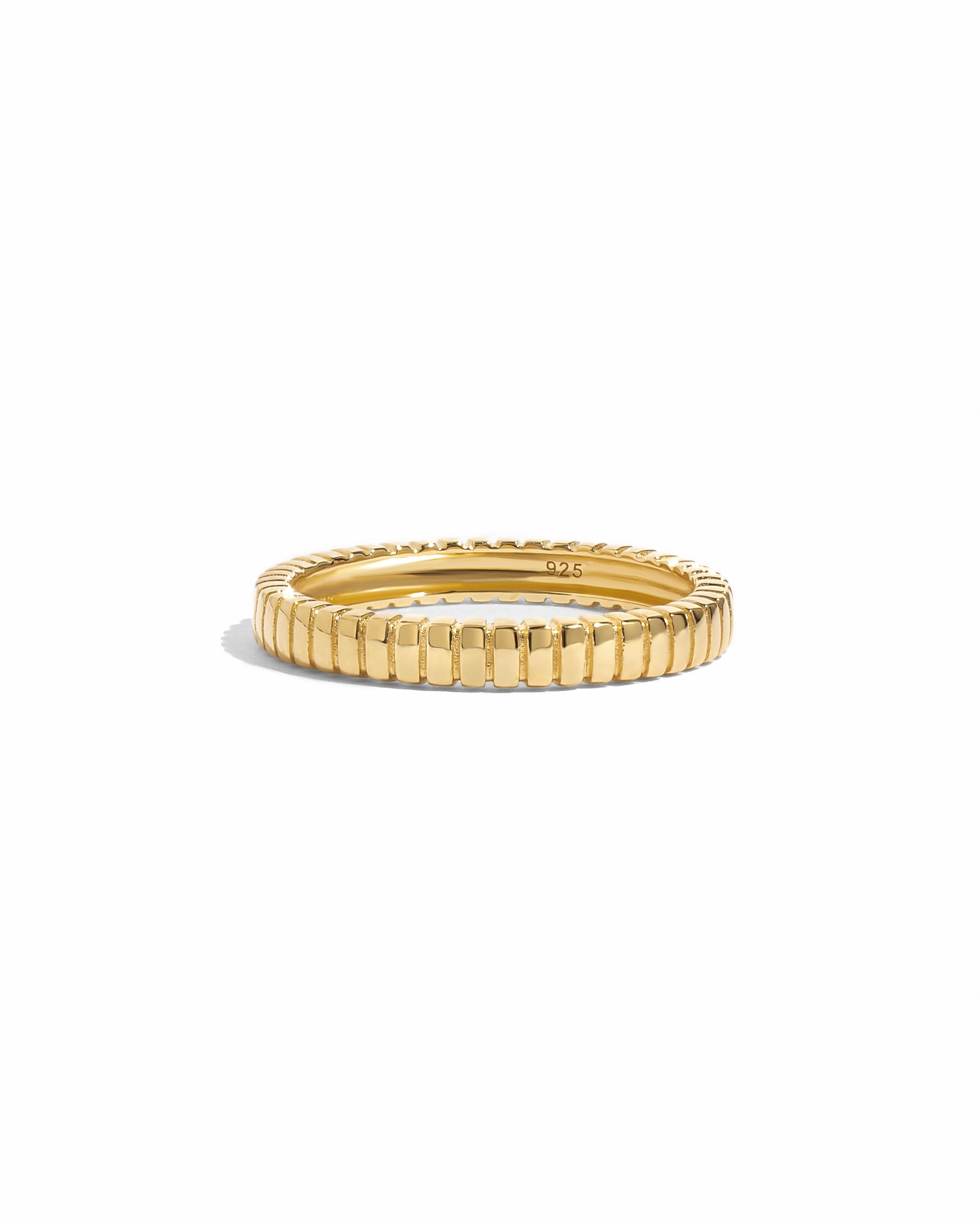 Dainty gold fluted ring on a white background.