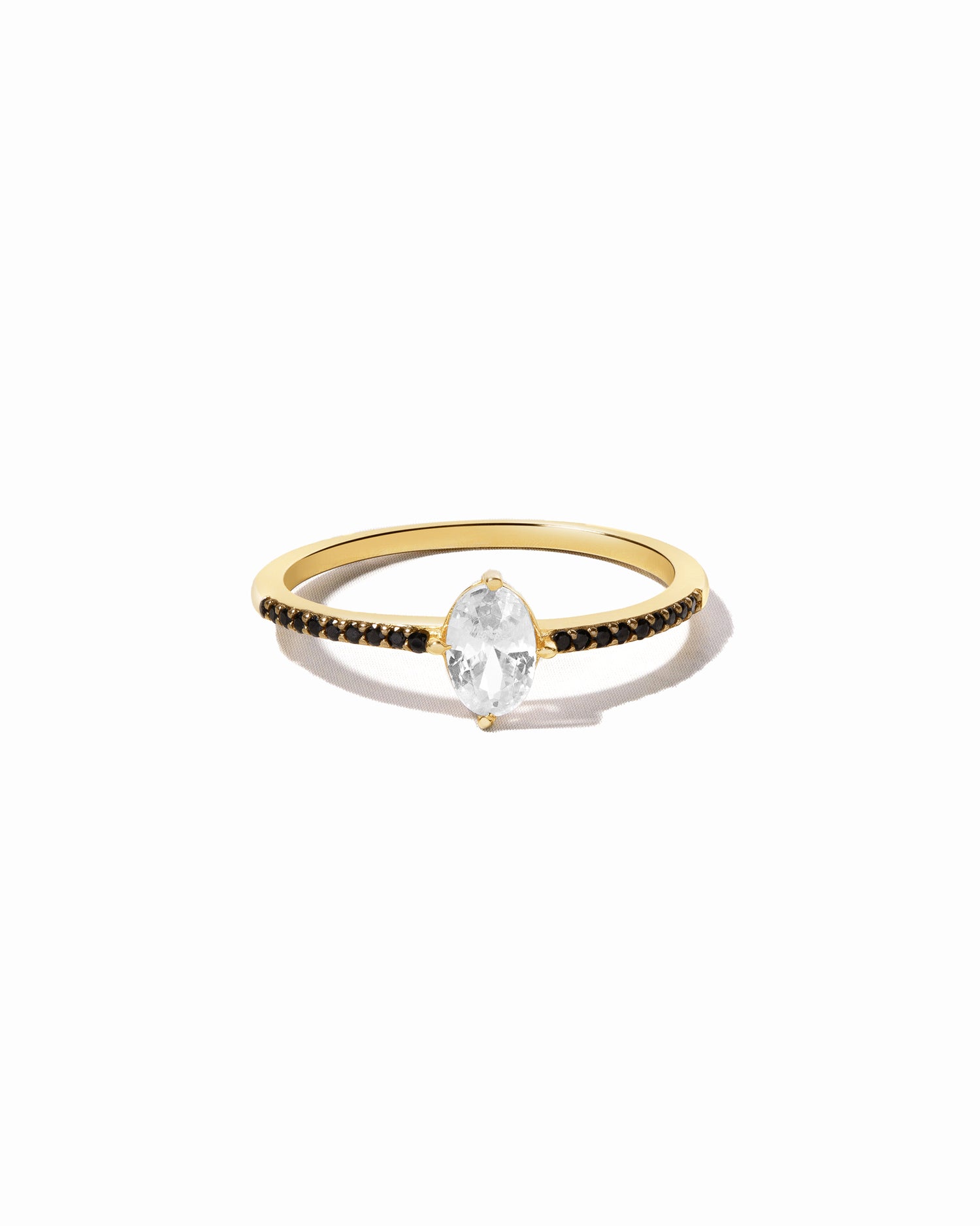 Gold marquise ring with black onyx stones on band.