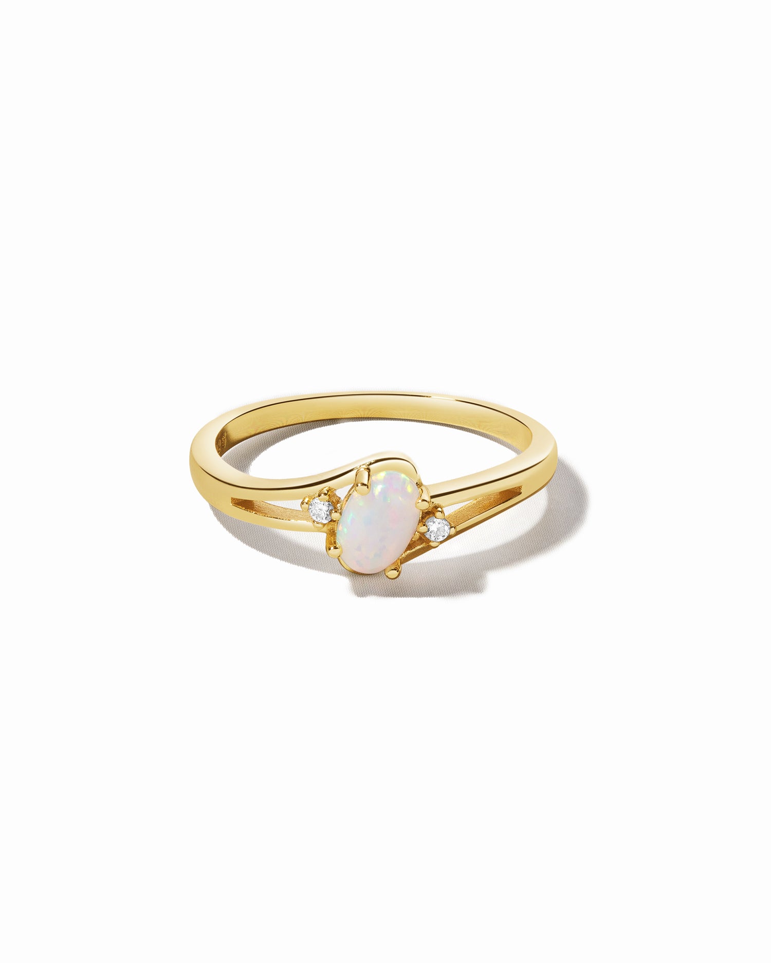 Gold opal oval ring with cz side stones.