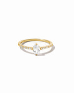 Gold marquise diamond ring with pavé diamonds on band.