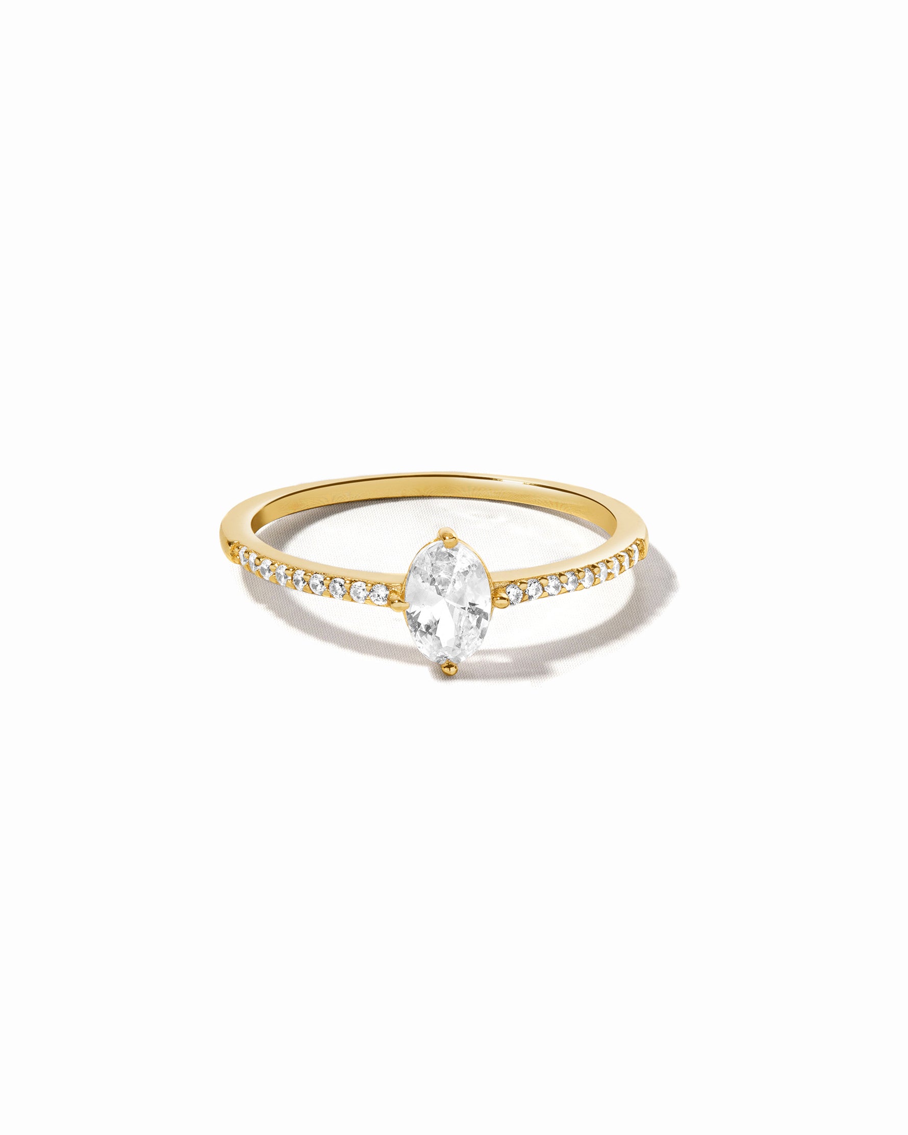 Gold marquise diamond ring with pavé diamonds on band.