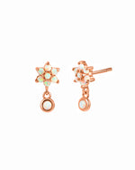 Dangling rose gold opal floral stud earrings.