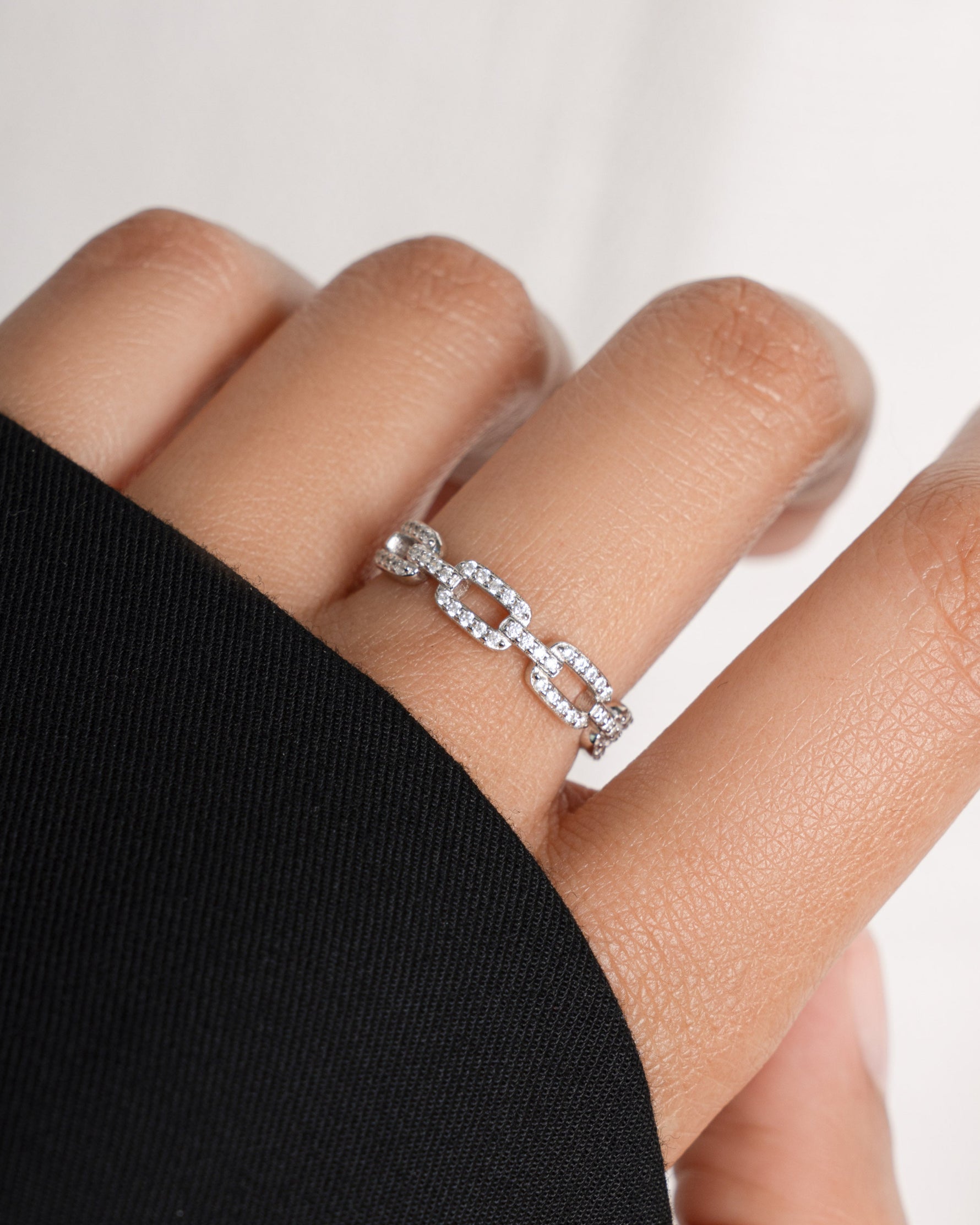 Sterling silver chain link ring with pave diamonds on model.