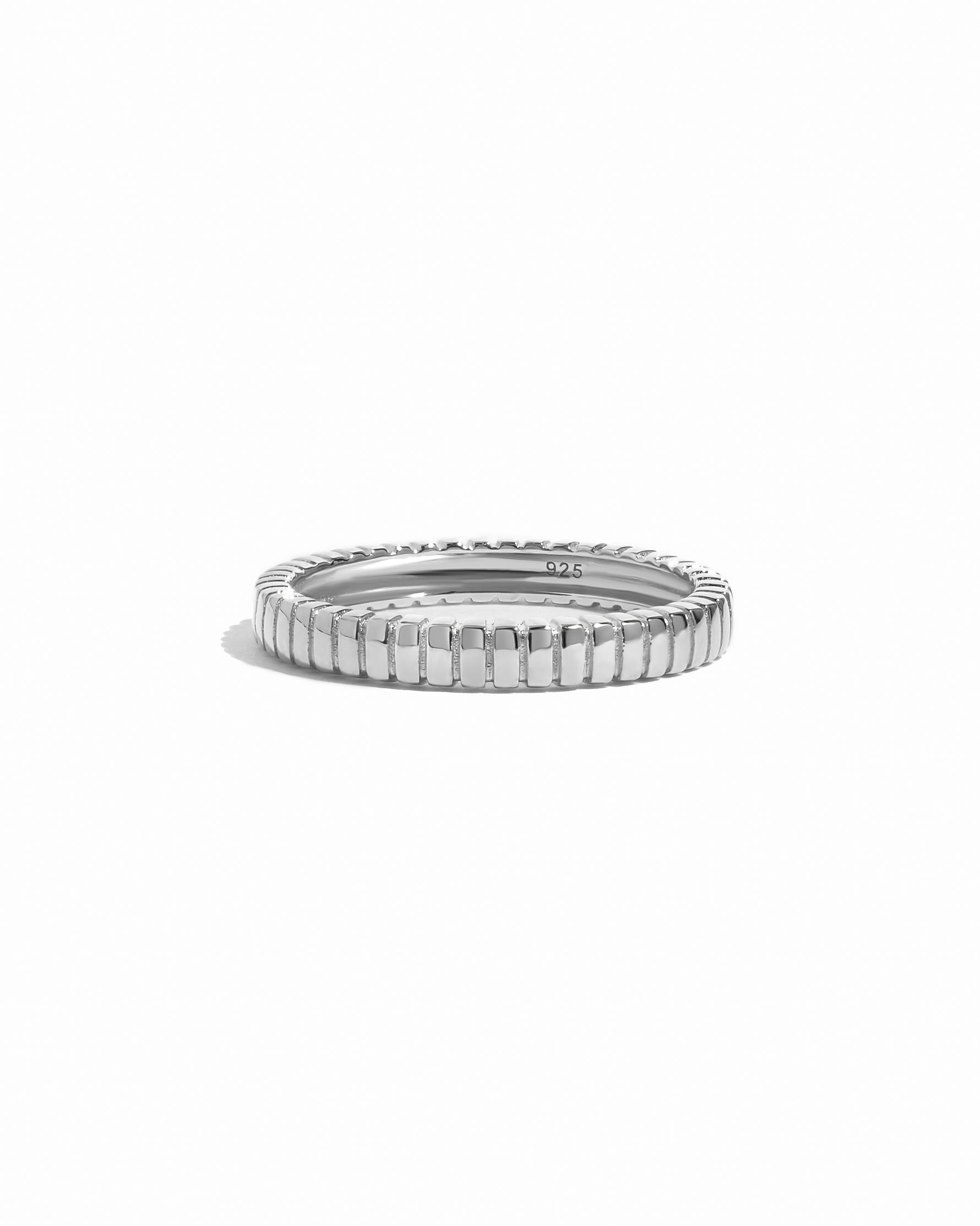 Minimalist sterling silver fluted ring on a white background.