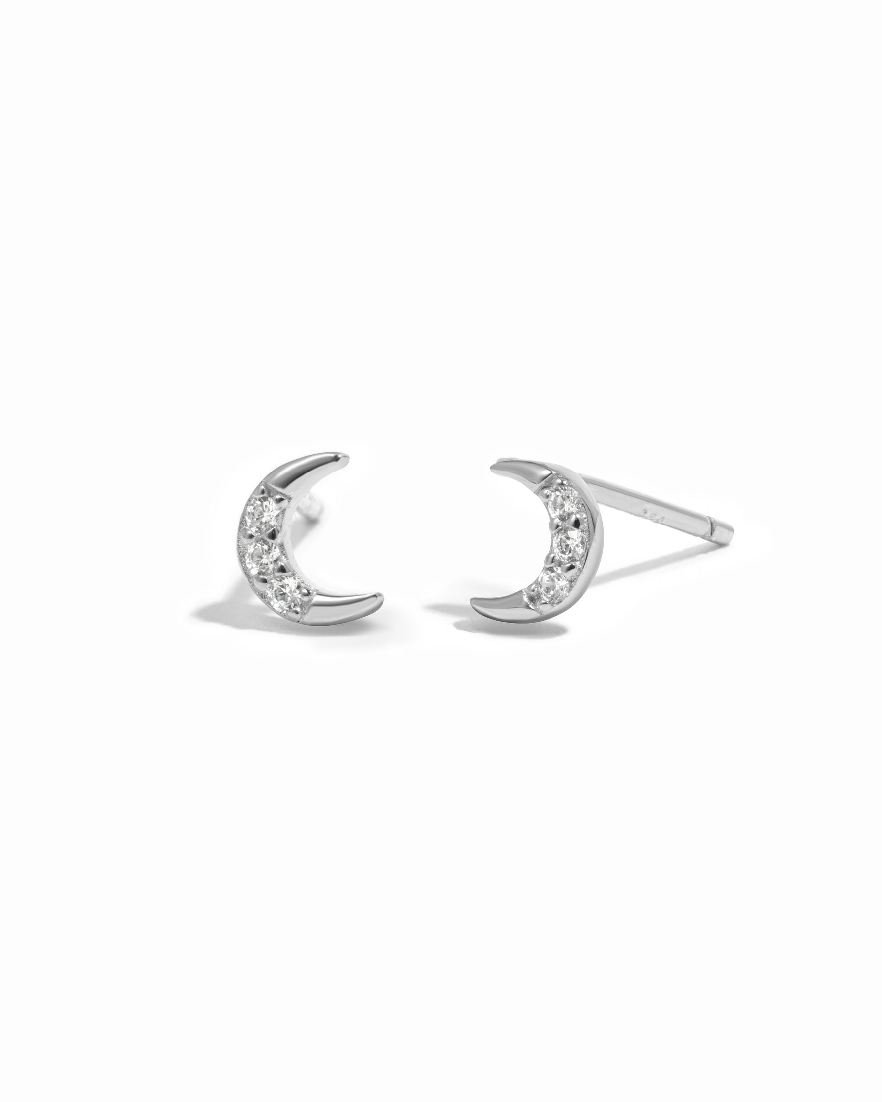 Sterling silver diamond moon stud earrings.