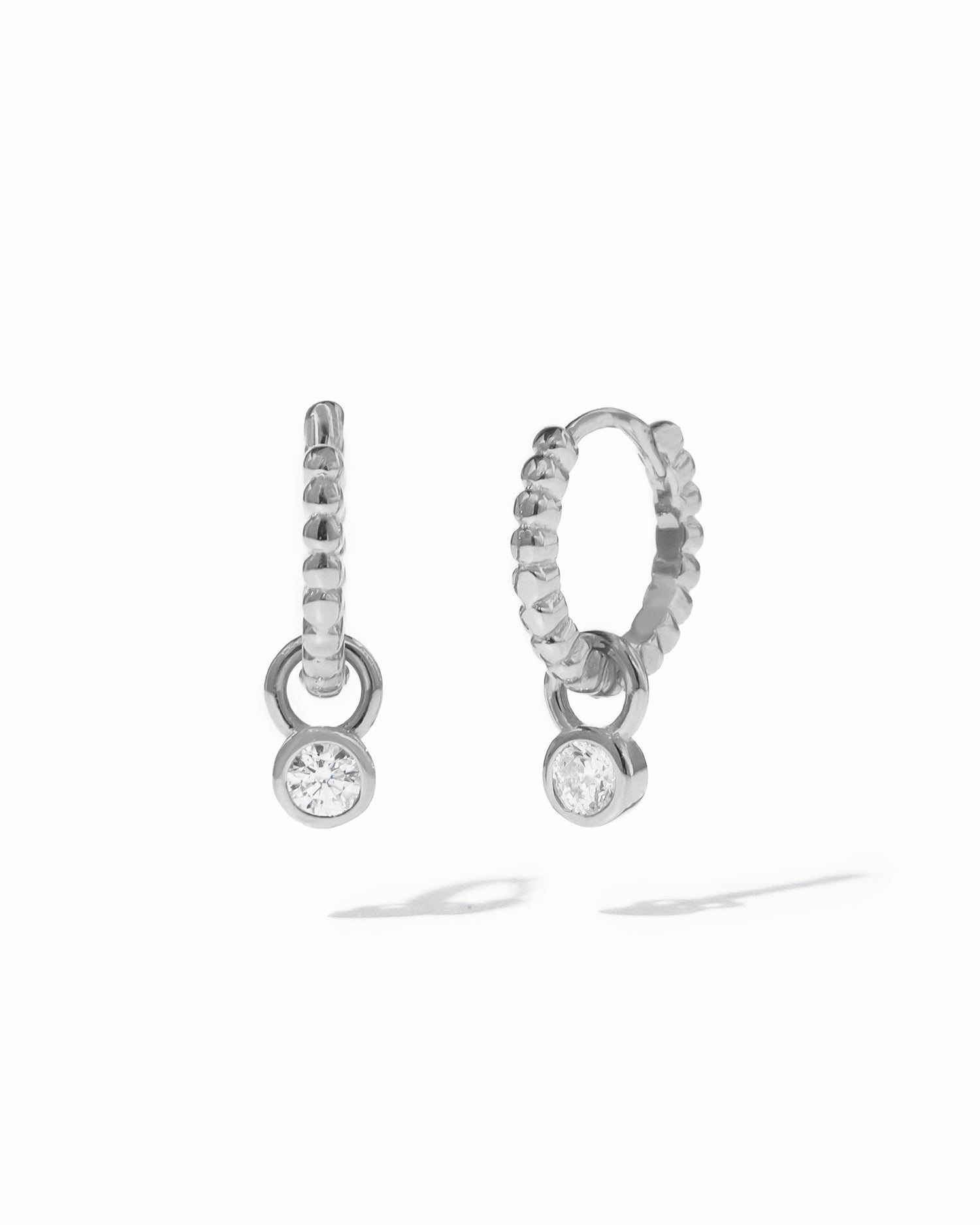 Sterling silver beaded huggie hoops with removeable bezel charm.