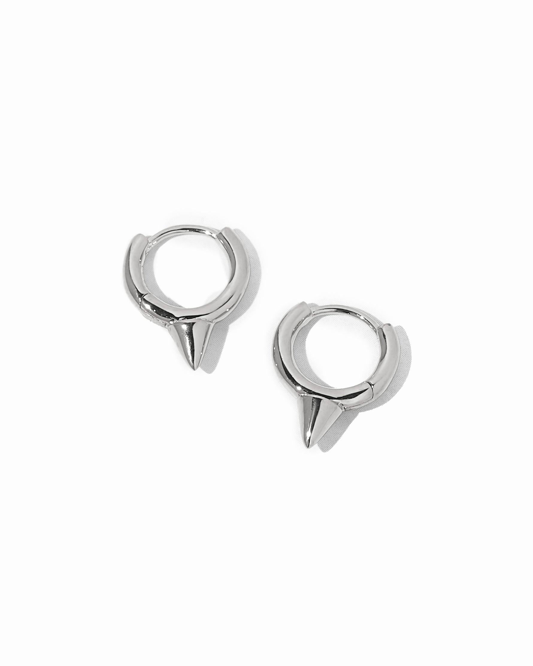 Sterling silver huggie earrings with spike detail.