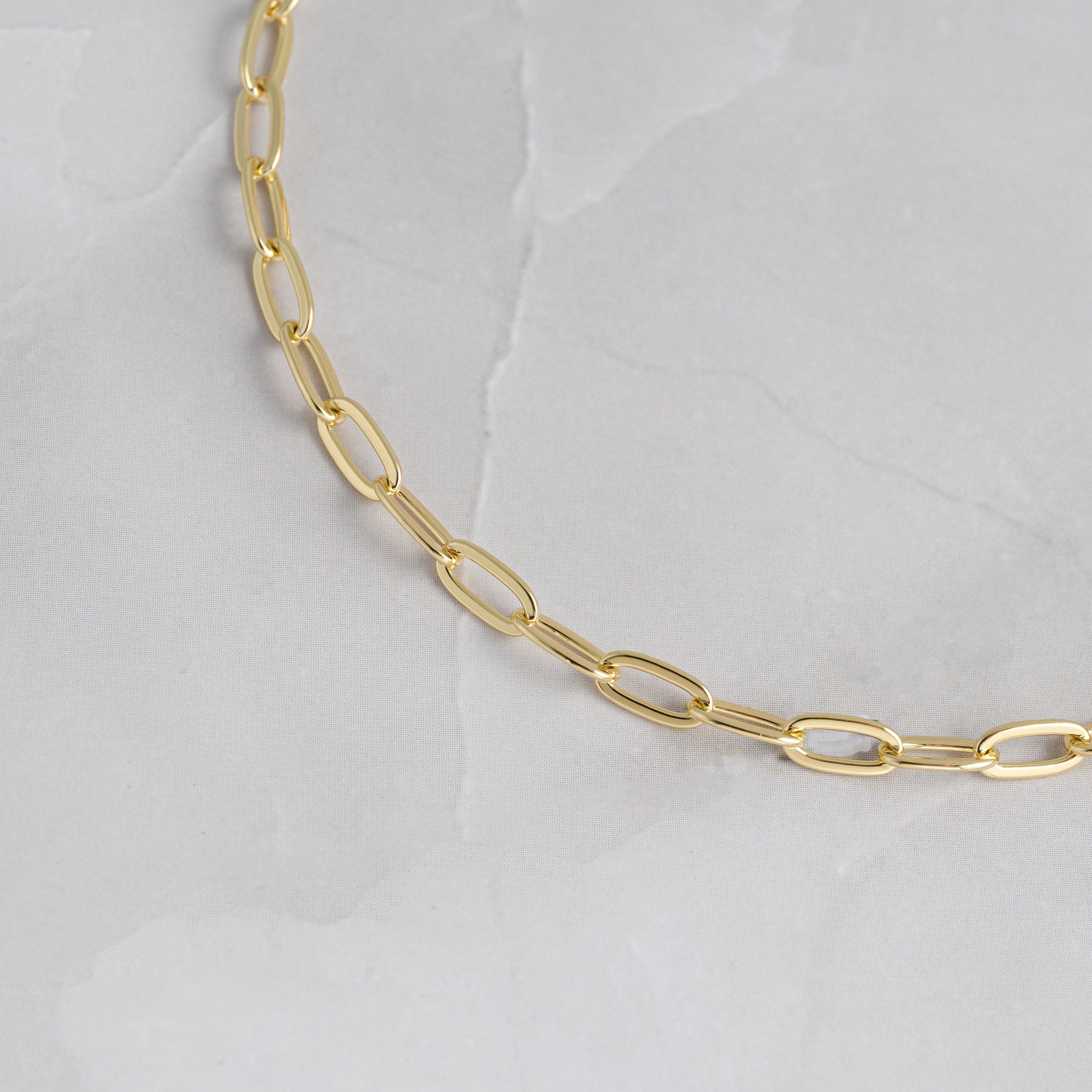 Closeup image of small gold paperclip chain