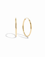 Closeup image of thin dainty hoop earrings