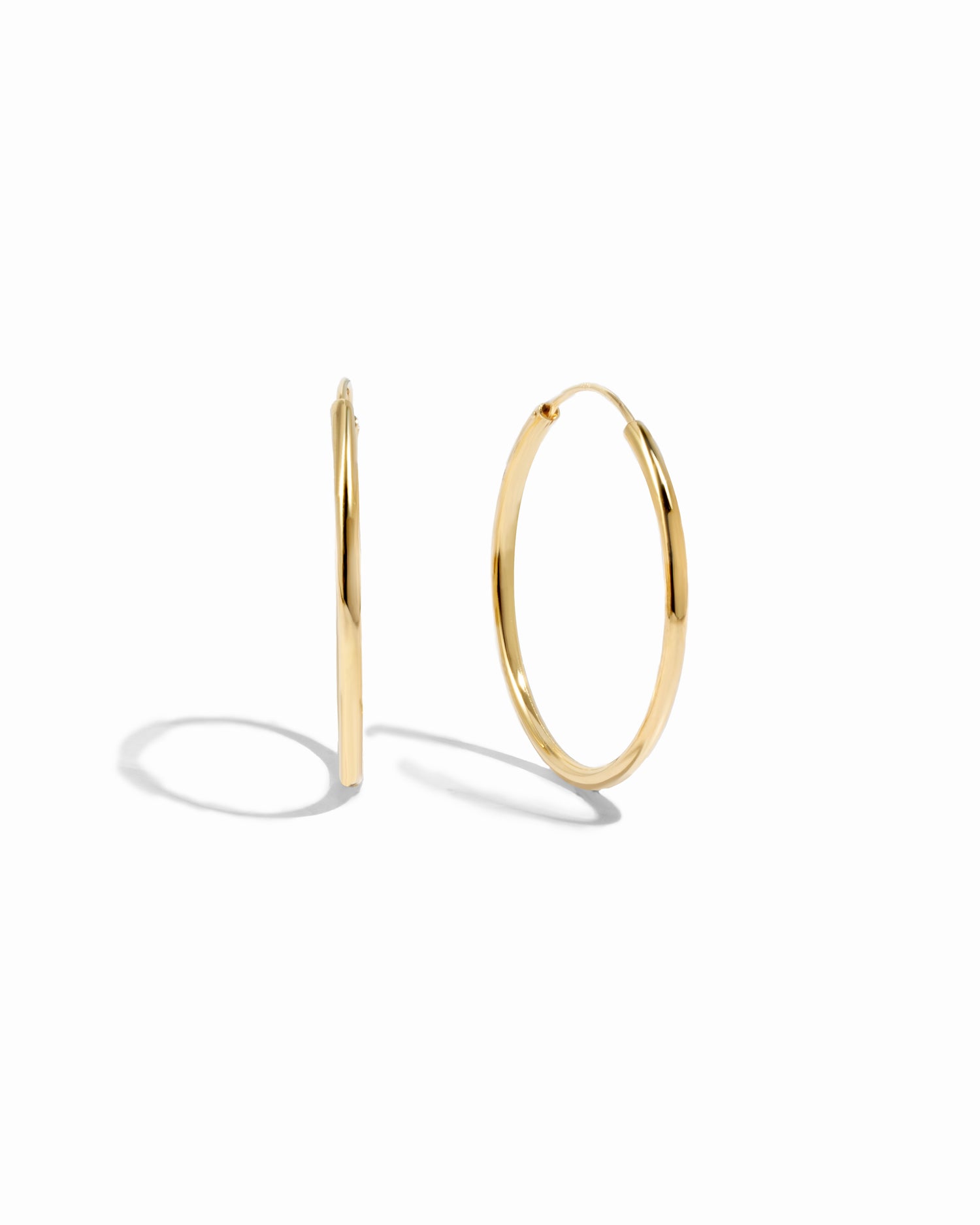 Closeup image of thin dainty hoop earrings