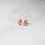 Rosegold plain heart stud earrings on marble background