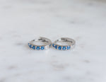 Dainty silver sapphire gemstone huggie hoops.