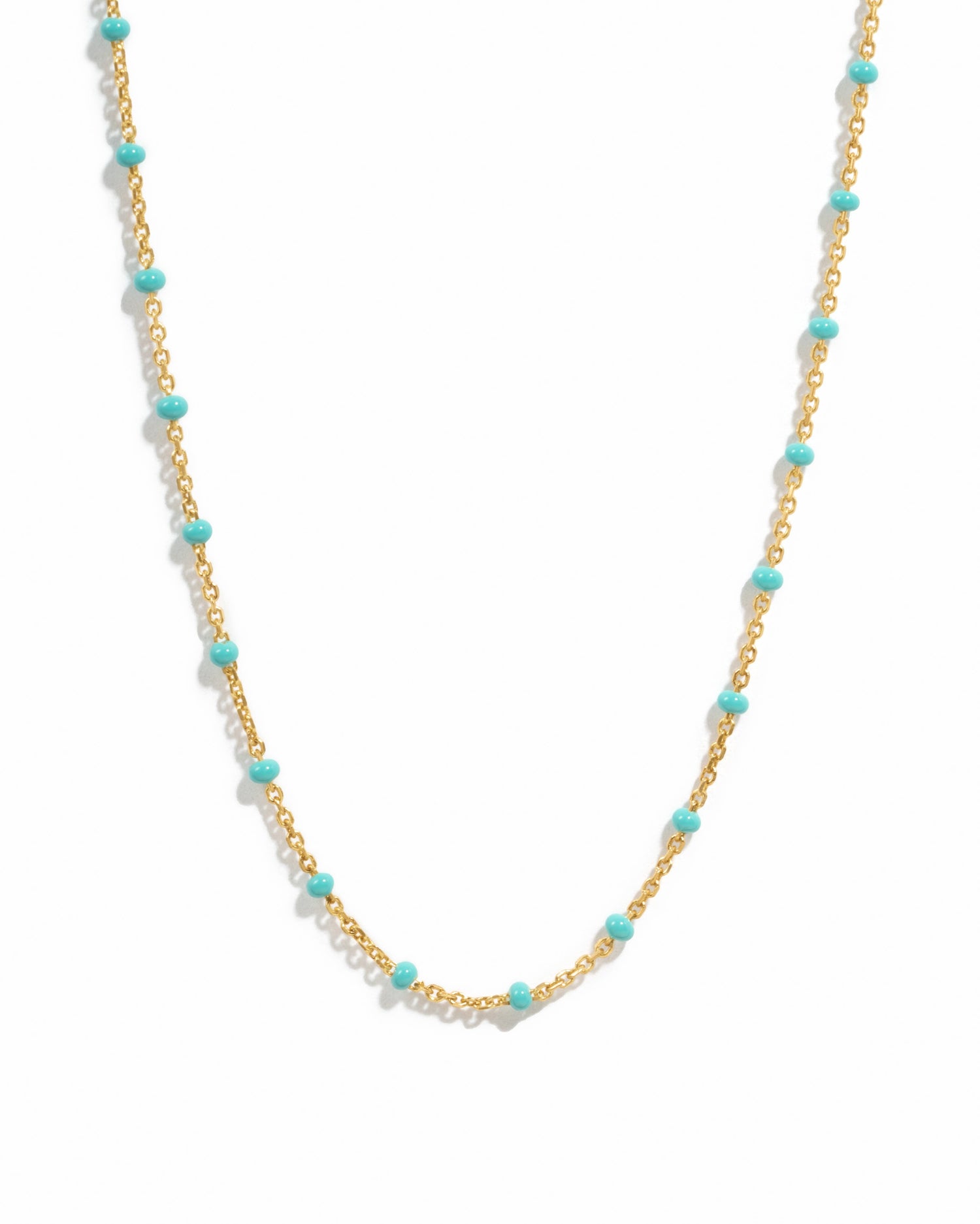 Delicate gold turquoise beaded enamel necklace on a white background.
