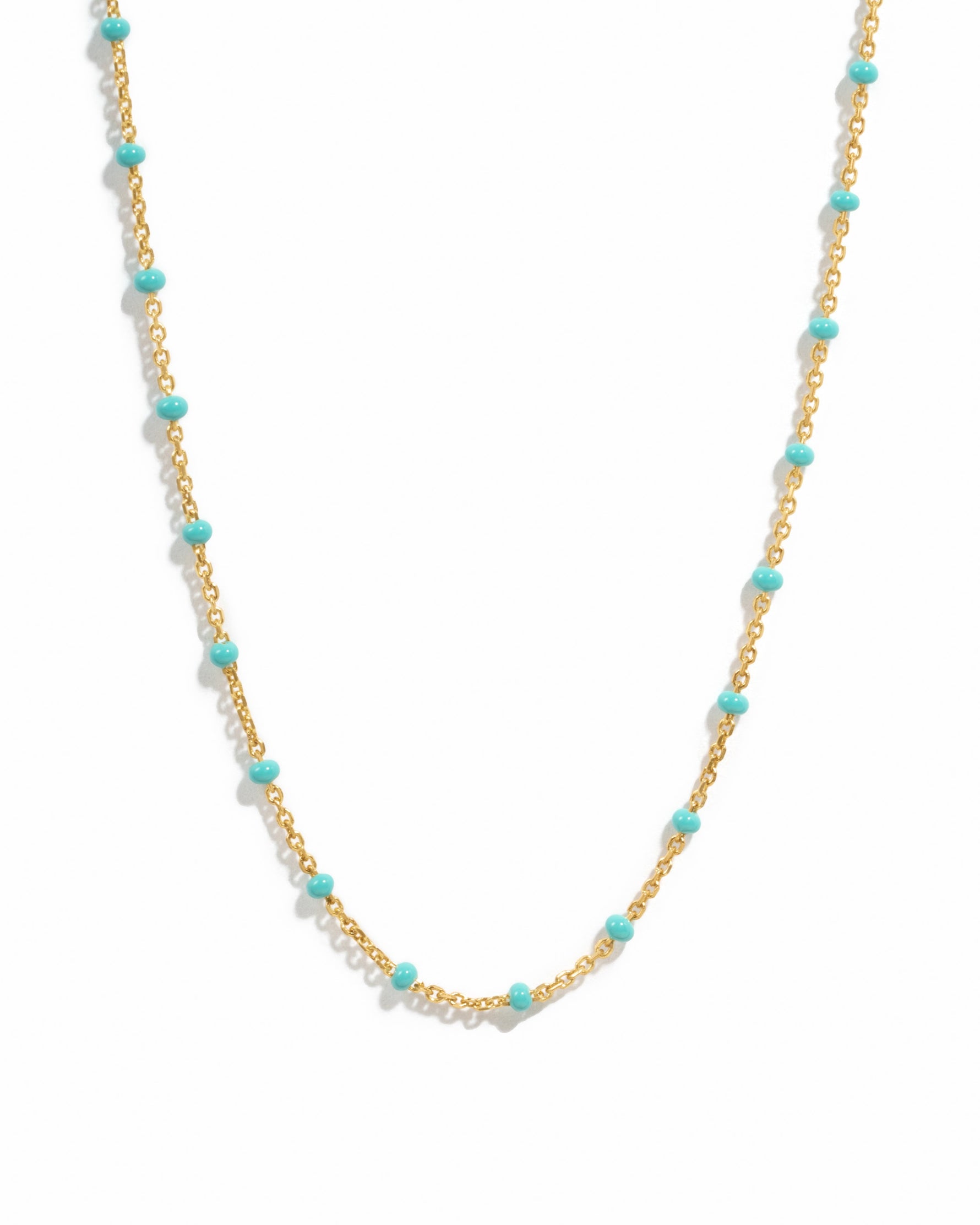 Delicate gold turquoise beaded enamel necklace on a white background.