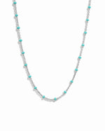 Silver dainty beaded turquoise chain necklace on white background. 