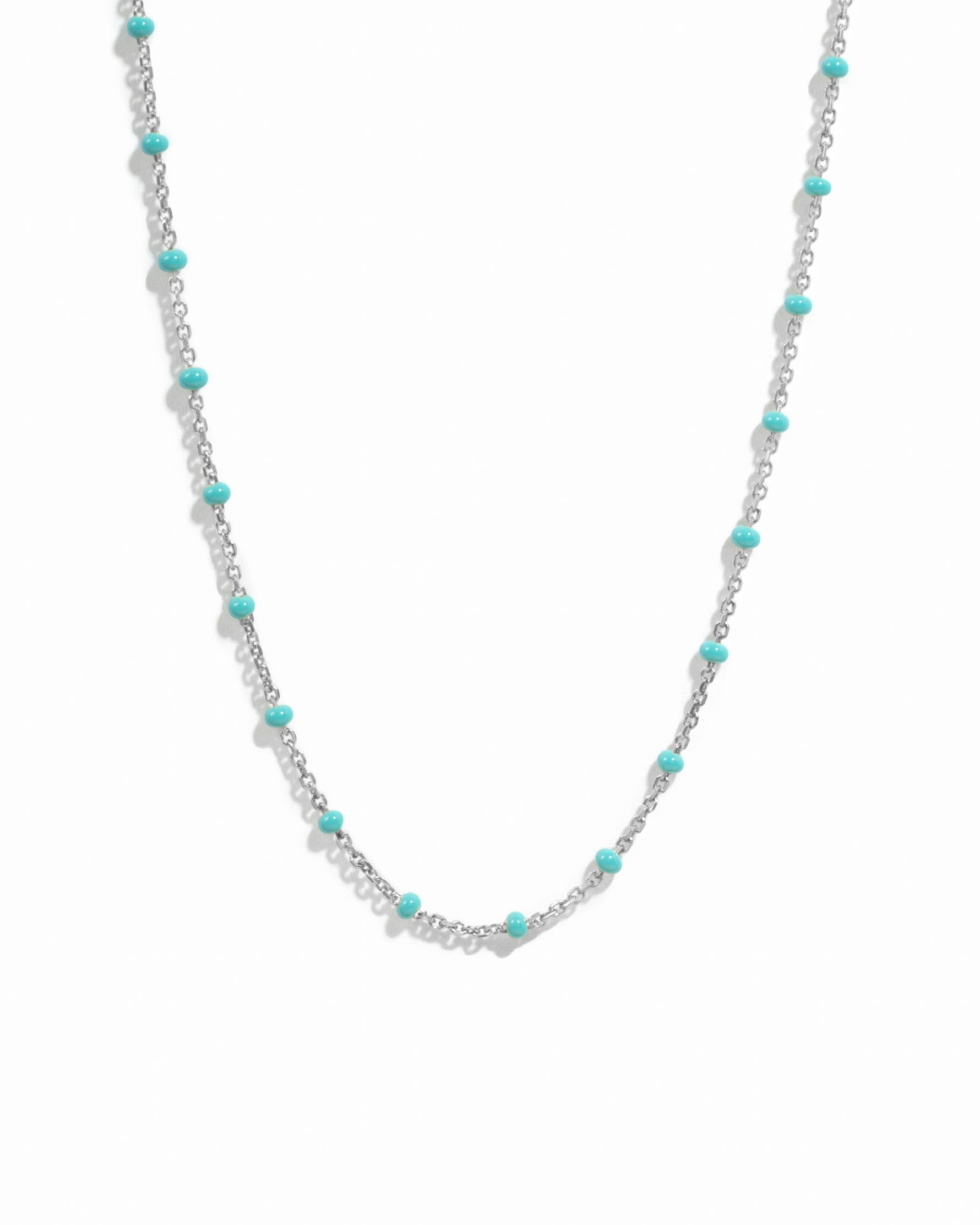 Silver dainty beaded turquoise chain necklace on white background. 