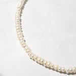 Up-close shot of beaded pearl necklace perfect for bridal jewelry looks.