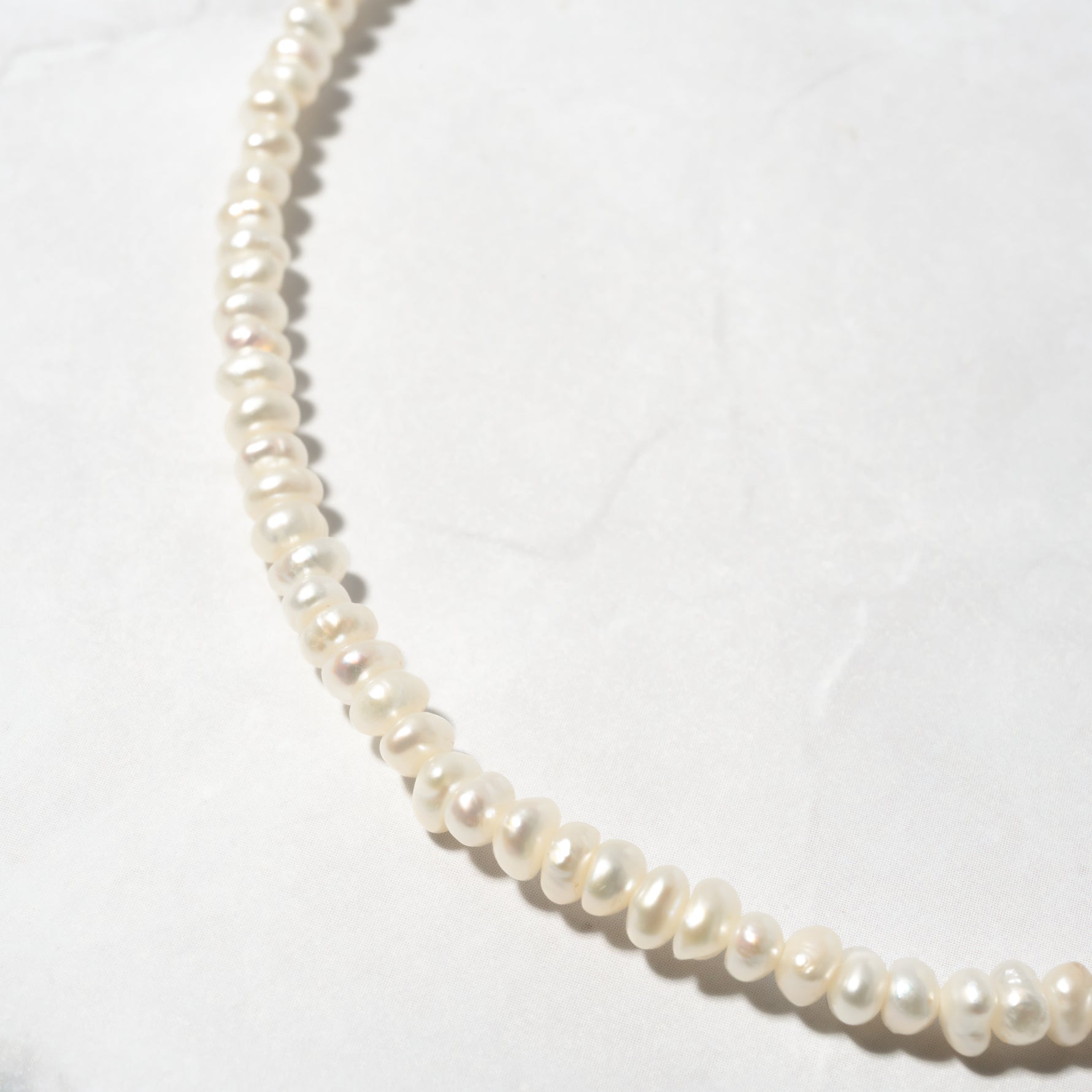 Up-close shot of beaded pearl necklace perfect for bridal jewelry looks.
