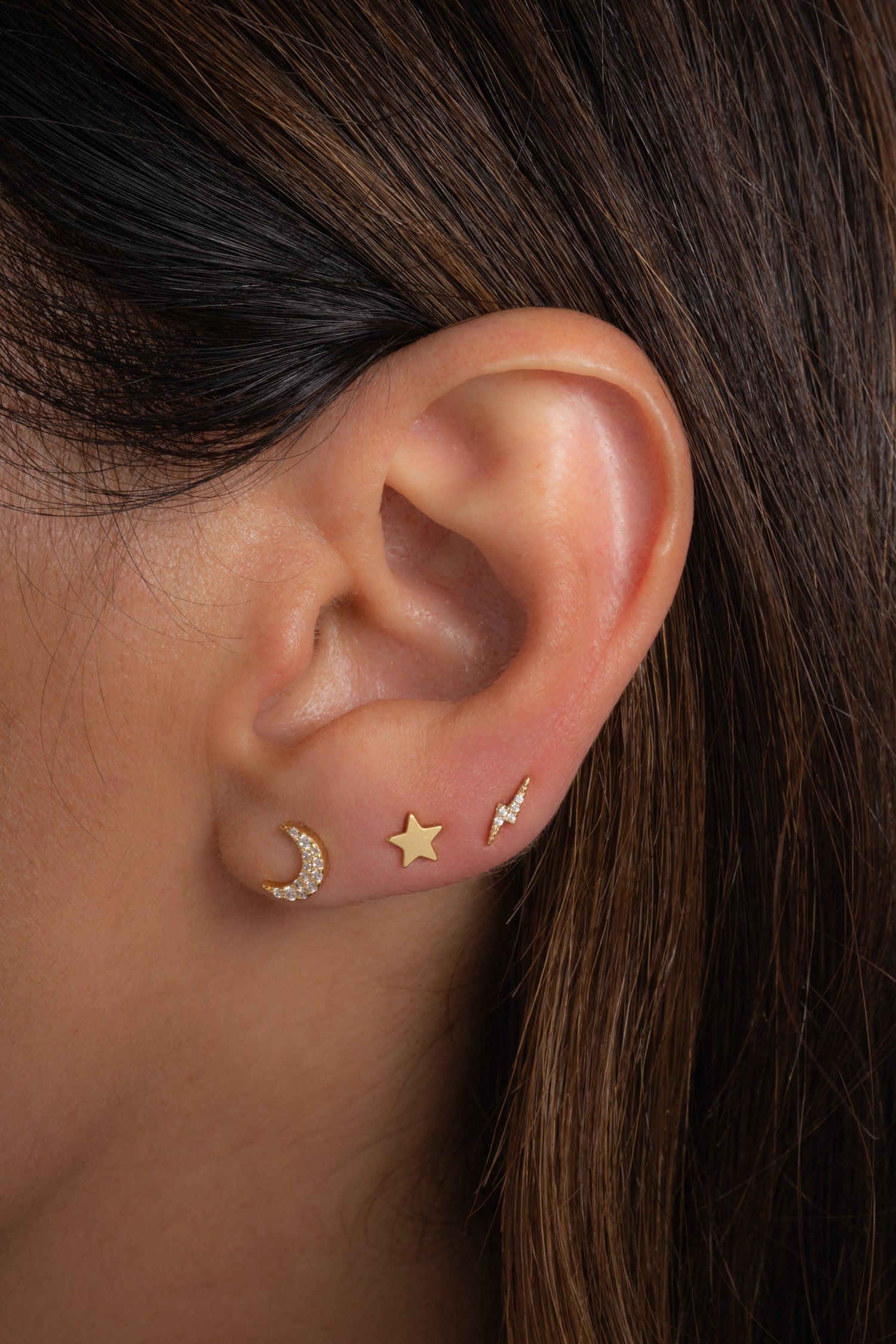 Gold star stud earrings by Sami Jewels featuring simple celestial star designs on a clean, minimalist style.