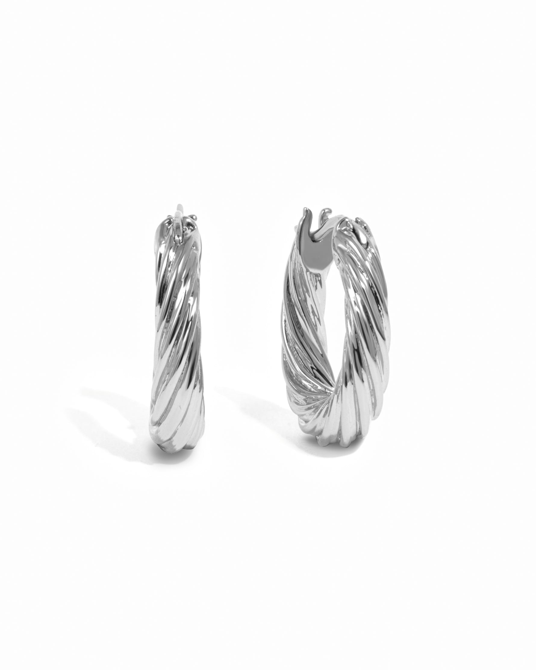 thick silver chunky hoops on white background.