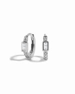 Silver small huggie hoops on a white background