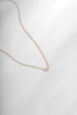 Gorgeous gold tiny cz heart pendant necklace on a white background. 