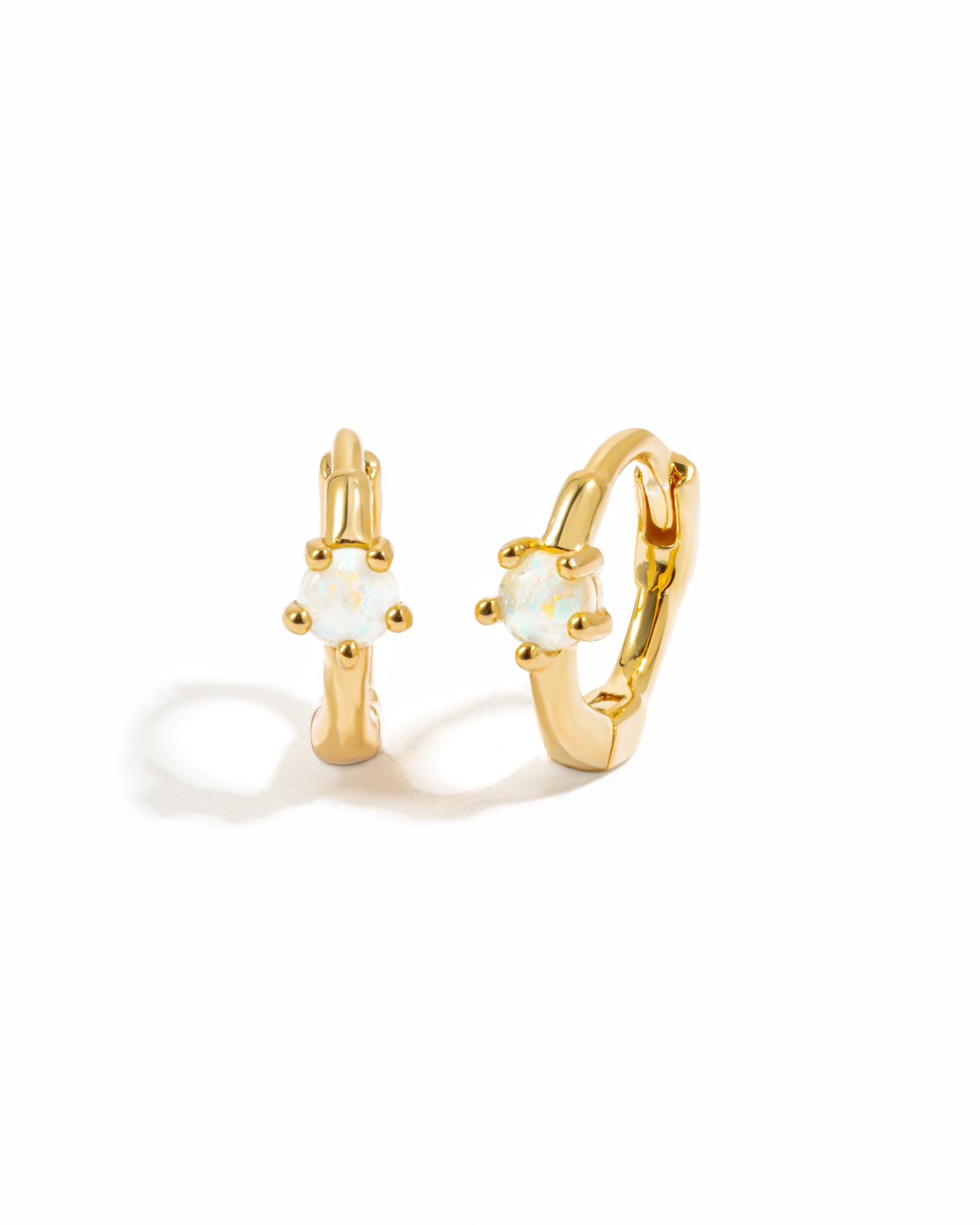 Dainty Opal Huggie Earrings on white background shown in 14k gold plated finish
