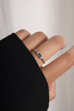 Model wearing minimalist sterling silver birthstone ring with aquamarine. 