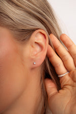 Model wearing classic dainty 925 sterling silver stud earrings. 