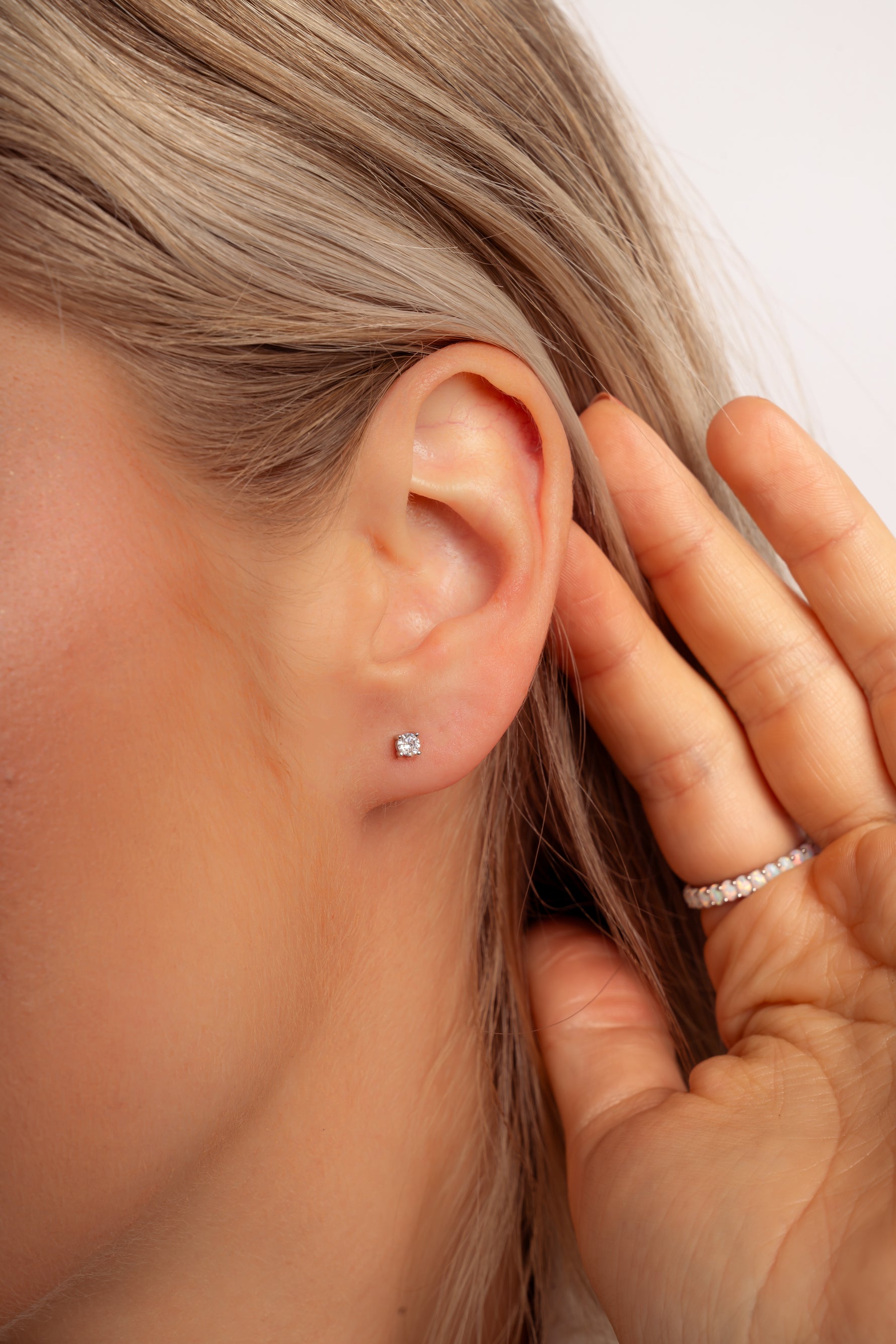 Model wearing classic dainty 925 sterling silver stud earrings. 