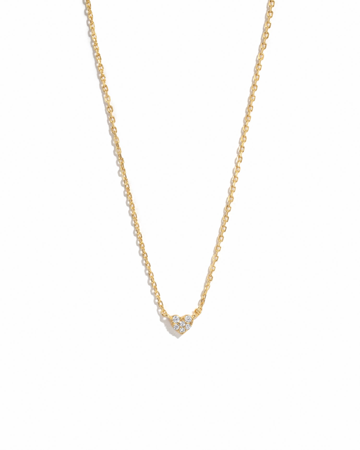 Delicate gold cz heart pendant necklace on a minimalist chain.