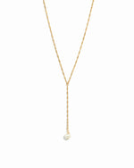 Gold pearl lariat necklace.