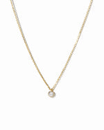 dainty gold tiny bezel pendant necklace on white background