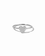 Plain solitaire sterling silver heart ring on white background.