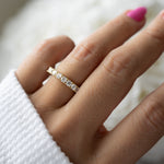 Model wearing elegant and timeless gold cz diamond eternity band. 