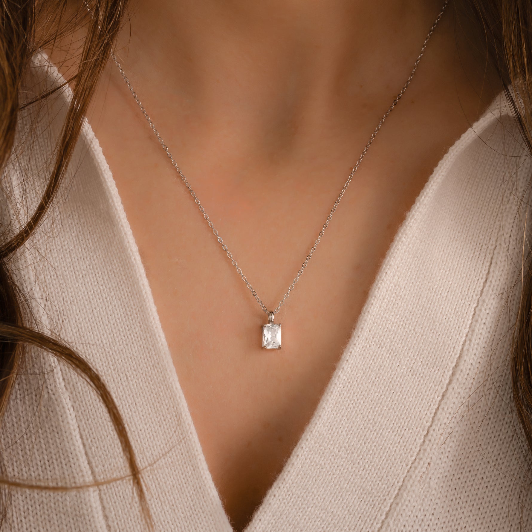 Model wearing dainty solitaire cz diamond pendant necklace.