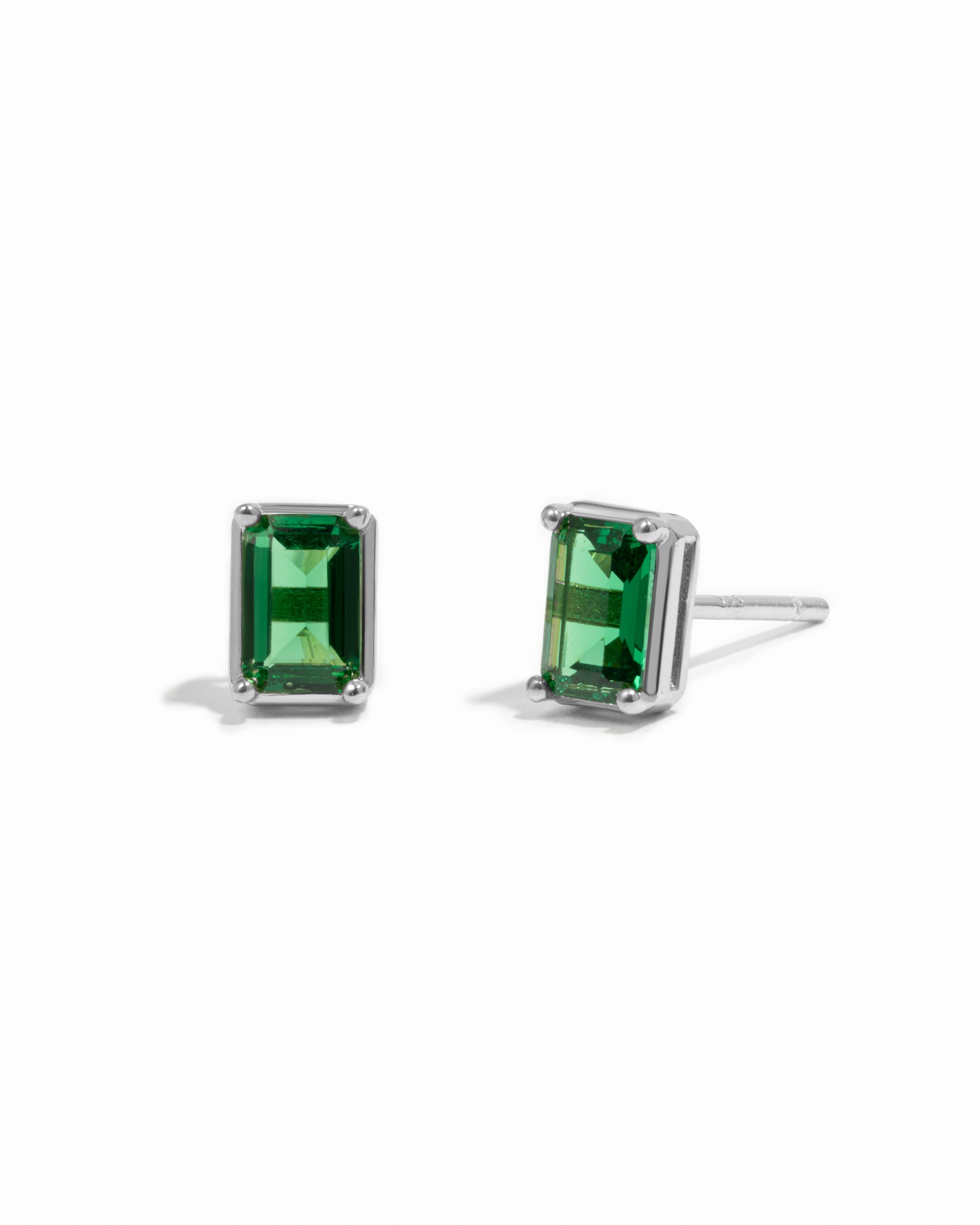 Sterling silver emerald-cut emerald gemstone stud earrings.