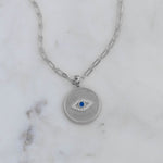 Sterling silver evil eye medallion circle pendant necklace on paperclip chain.