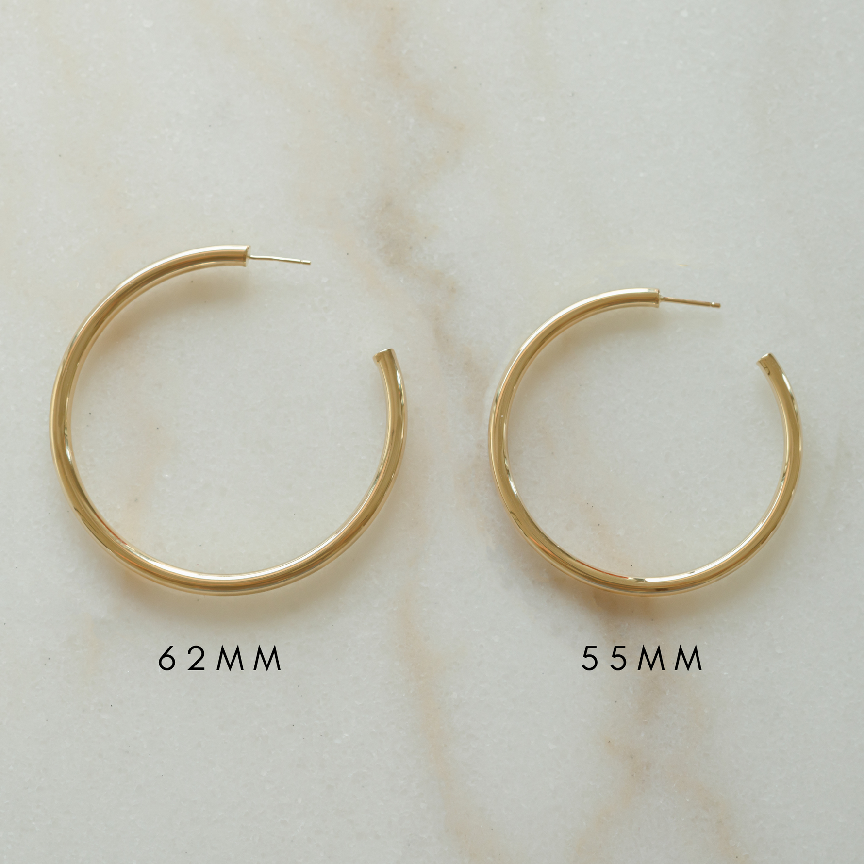 Statement gold tube hoops similar to the ones Madison Beer always wears. 