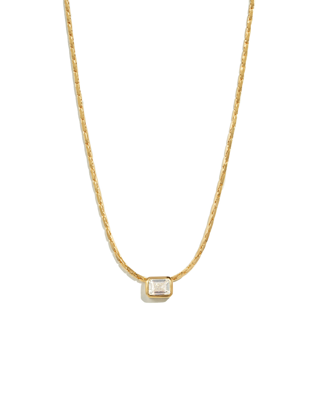 Gold baguette bezel diamond statement pendant necklace on white background